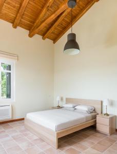 a bedroom with a large bed with a wooden ceiling at VILLA MYLOS in Danilia