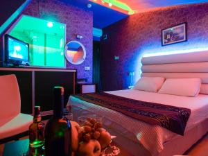 a bedroom with a bed and a tv and bottles of wine at Hotel Timya in Istanbul