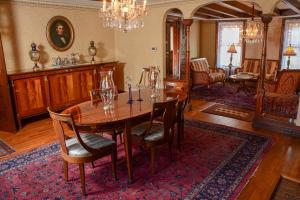a dining room with a wooden table and chairs at The Towers Bed & Breakfast in Milford