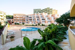 a large apartment building with a swimming pool in front of it at Orlando 85 in Adeje