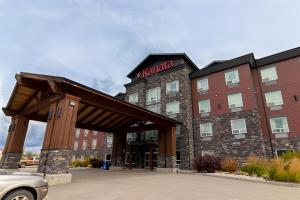 a hotel with a sign on the front of it at Kanata Whitecourt in Whitecourt