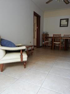 a living room with a couch and a table and chairs at Departamento Víctoria in Mar del Plata