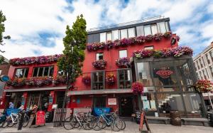 a red building on a street with bikes parked in front at Clarendon Suites in Dublin