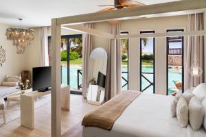 a bedroom with a bed and a living room at Sanctuary Cap Cana, a Luxury Collection Resort, Dominican Republic, Adult All-Inclusive in Punta Cana