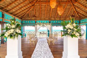a wedding reception in a pavilion with white flowers and chairs at Sanctuary Cap Cana, a Luxury Collection Resort, Dominican Republic, Adult All-Inclusive in Punta Cana +277 photos