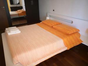 モンテジルヴァーノにあるAries Domus Montesilvanoのベッドルーム1室(大型ベッド1台、オレンジのシーツ付)