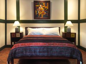 a bedroom with a large bed with two night stands at Maison Houng Chanh - Luang prabang in Luang Prabang +16 photos