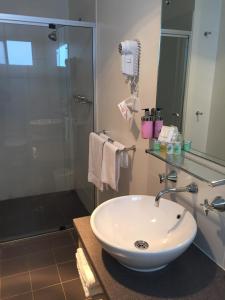 a bathroom with a white sink and a shower at Kangaroo Island Seafront in Penneshaw