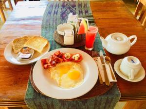 a breakfast table with eggs and toast and a cup of coffee at Arya Amed Beach Resort and Dive Center in Amed