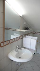 a bathroom with a sink and a mirror at Guesthouse Villa AnnaDora in Brseč