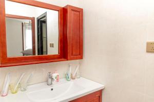 a bathroom with a sink and a mirror at Henan Kaifeng·Henan University· Locals Apartment 00170030 in Kaifeng +18 photos