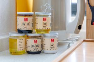 a group of jars of honey sitting on a kitchen counter at Henan Kaifeng·Henan University· Locals Apartment 00170030 in Kaifeng