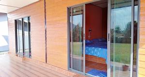 a room with glass doors with a bed in it at เฟรนด์แคมป์ in Khao Kho