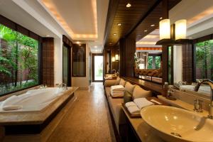 a bathroom with two sinks and a large tub at Trisara - SHA Plus in Nai Thon Beach