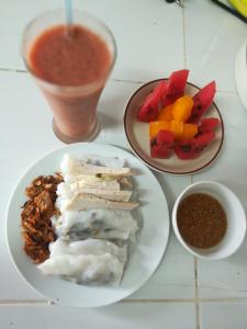 a table with a plate of food and a bowl of salsa at Phonepraseuth Guesthouse in Luang Prabang