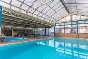 a large swimming pool with a large ceiling at Sleepwell Motel in Albany