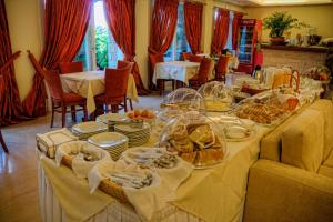 a long table with plates of food on it at Archipelagos Hotel in Fournoi