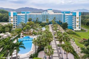 an aerial view of a resort with a pool and palm trees at Disney's Hollywood Hotel in Hong Kong