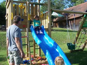 a man and a child playing on a playground at Penzion Venkoff in Sázava