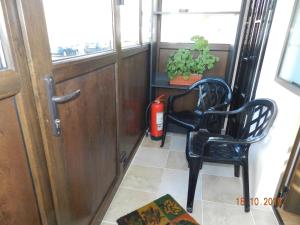 a fire hydrant sitting next to a chair and a fire extinguisher at Apartament Cristina cu doua dormitoare & balcon & parcare in Onești