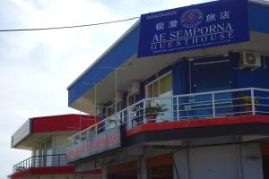 a building with a blue sign on top of it at AE Semporna Guesthouse 极潜旅店 in Semporna