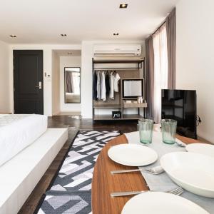a living room with a couch and a table at Warm Window Silom in Bangkok