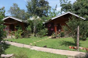 a house with a garden in front of it at Chiang Dao Story Camp in Chiang Dao