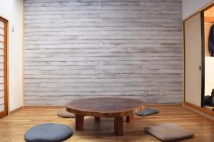 a wooden table in a room with a wooden wall at Guest House Minato in Miyako