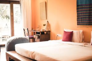 a bedroom with a bed and a table and a window at iRoHa Garden Hotel & Resort in Phnom Penh