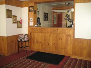 a room with a wooden counter and a mirror at Midtown Hotel in Parry Sound