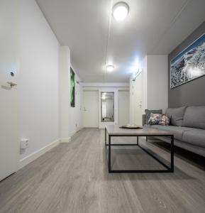 a living room with a couch and a coffee table at Abisko Hostel in Abisko