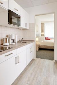 
a kitchen with a white counter top and white cabinets at Gästehaus Pauline in Berlin
