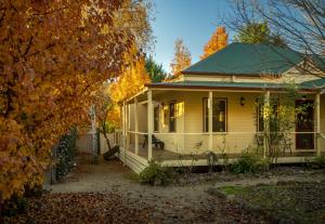 a white house with a green roof at Autumn Beauty - Cottage 4 in Bright