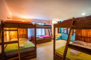 a room with three bunk beds in it at Laki Uma Villa - Male Only in Canggu