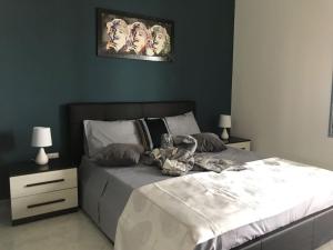 a bedroom with a large bed and two night stands at kalantha in Minervino di Lecce