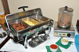 a food processor with a tray of food on a counter at Land- und Golfhotel Alte Fliegerschule in Eisenach