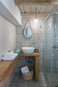 a bathroom with a sink and a glass shower at moonhouse in Skiathos +14 photos