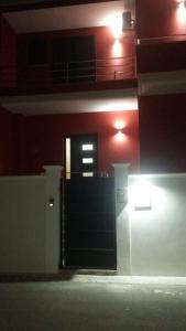 a black door in a building with red walls at kalantha in Minervino di Lecce