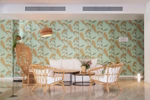 a dining room with a table and chairs with a wallpaper at The 15th Boutique Hotel by Bondia Group in Lloret de Mar
