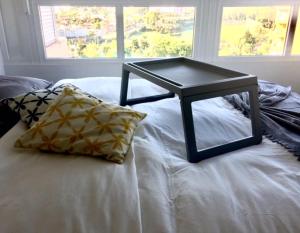 a table on top of a white bed with a pillow at La Colina in Torremolinos