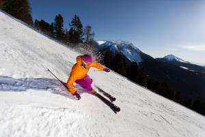 a person is skiing down a snow covered slope at Hotel Langeshof in Anterivo