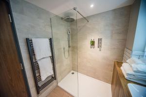 a bathroom with a shower with a glass door at Thonock Park B&B in Gainsborough