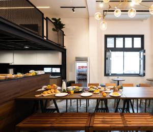 a dining room with a table with fruit on it at Warm Window Silom in Bangkok