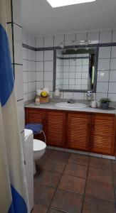 a bathroom with a sink and a toilet and a mirror at Casa Óscar in Los Llanos de Aridane