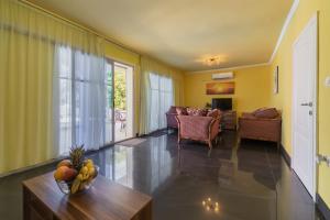 a living room with a bowl of fruit on a table at Villa Tivat in Tivat