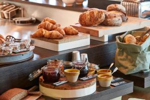 a bakery with bread and croissants and other pastries at 25hours Hotel Hamburg HafenCity in Hamburg