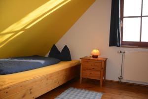 a bedroom with a wooden bed and a window at Ferienhof Brune in Zempow