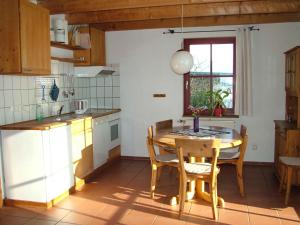 a kitchen with a table and chairs in a kitchen at Ferienhof Brune in Zempow
