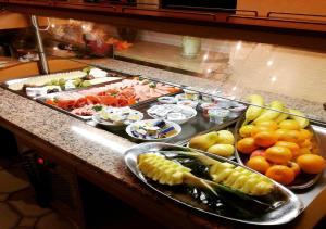 a buffet with many different types of fruits and vegetables at Hotel Jägerhof in Roth