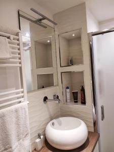 a bathroom with a white sink and a shower at Suite Il Letto Sotto Il Tetto in Catania